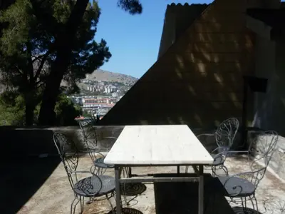 a table and chairs on a patio with a view at Villa Giannì in Palermo