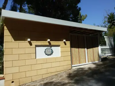 a brown building with a door and a sign on it at Villa Giannì in Palermo