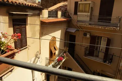a table with plates of food on it with a window at BnB DonnaLaura in Carini