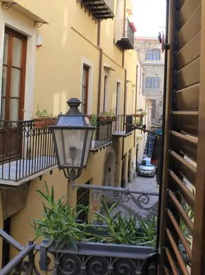 an alley with a street light on a building at Casetta Nostra in Palermo