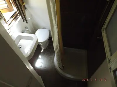 a bathroom with a toilet and a sink and a shower at Casetta Nostra in Palermo