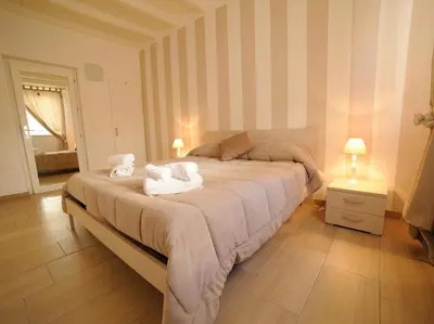 a bedroom with a large bed with towels on it at Le Quattro Perle in Terrasini