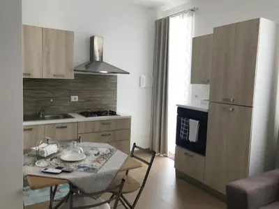 a kitchen with a table and a sink and a stove at Le Quattro Perle in Terrasini