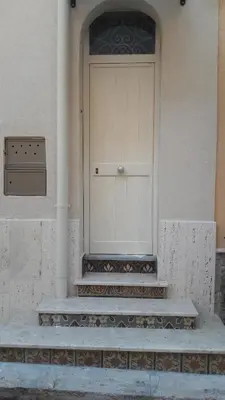 a front door of a building with steps and a door at Casa Vacanze TAMARA in Balestrate