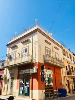 a building on the corner of a street at Casa Vacanze TAMARA in Balestrate