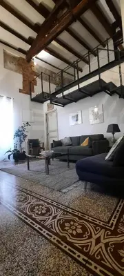 a living room with a couch and a table at Speciale Apartment in Palermo