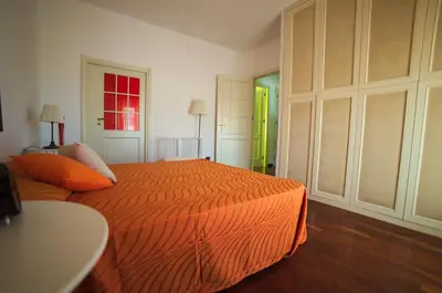 a green kitchen with white cabinets and a sink at L'Attico di Gizi in Palermo