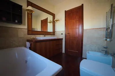 a bedroom with a bed with an orange comforter at L'Attico di Gizi in Palermo
