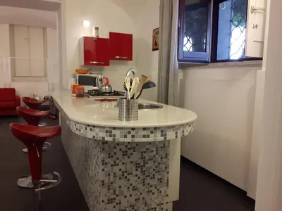 a kitchen with a counter with utensils at A un passo dal Massimo in Palermo