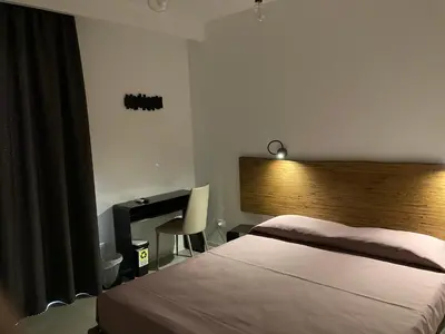 a bedroom with a bed and a desk and a bed sidx sidx sidx at Catalina in San Vito lo Capo