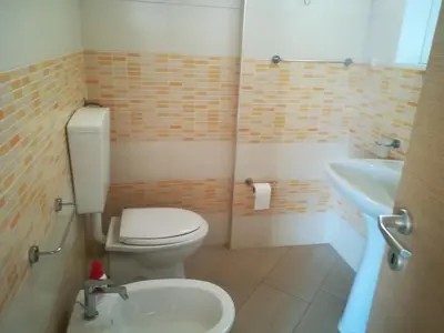 a small bathroom with a toilet and a sink at Vicino al mare e lontano dai rumori in Alcamo Marina
