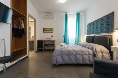a bedroom with a bed and a desk in a room at My Way - Suite - Rooms - Palazzo San Matteo in Palermo