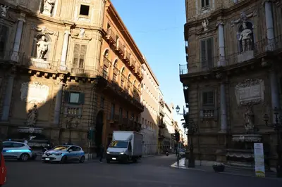 a city street with cars parked in front of buildings at My Way - Suite - Rooms - Palazzo San Matteo in Palermo