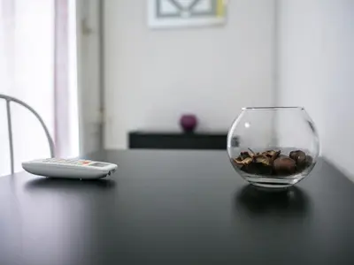 a glass bowl of nuts and a remote control on a table at Liberty Apartment in Palermo