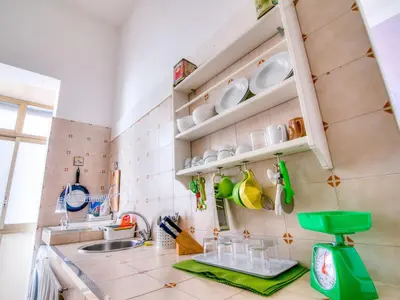 a kitchen with a sink and a counter with dishes at Liberty Apartment in Palermo