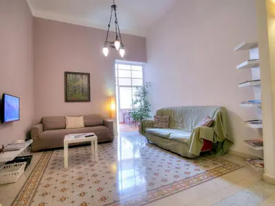 a living room with a couch and a table at Liberty Apartment in Palermo