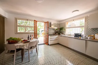 a kitchen with a table and a counter top at Casa del carrubo in Carini