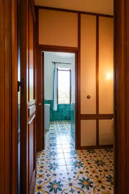 a hallway of a bathroom with a tile floor at Casa del carrubo in Carini