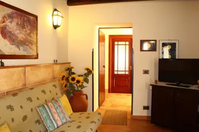 a living room with a couch and a television at Casale Maddalena in Carini