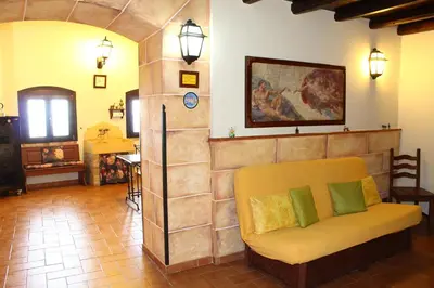 a living room with a couch and a painting on the wall at Casale Maddalena in Carini