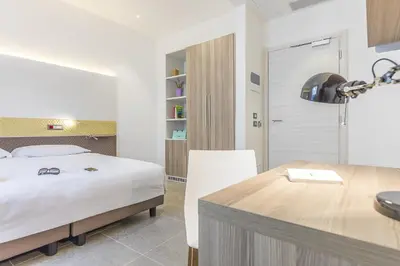 a bedroom with a bed and a dining table at Camplus Palermo Normanni - in Palermo