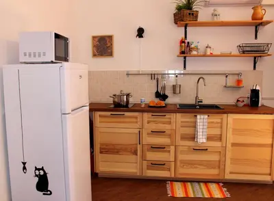a kitchen with a white refrigerator and wooden cabinets at Pirtuso Del Porto in Palermo