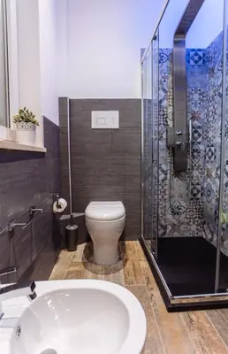 a bathroom with a toilet and a shower at Politeama Luxury Suites in Palermo