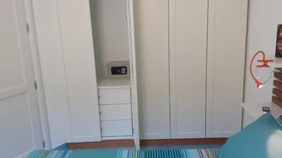 a corner of a room with white cabinets at Residenza del Mare & SPA in San Vito lo Capo