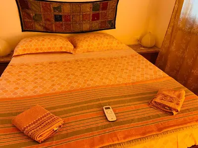 a bed with a remote control sitting on top of it at House in Mondello in Mondello