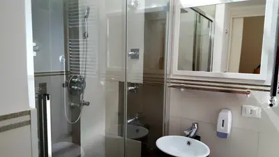 a bathroom with a shower and a sink and a mirror at Rest and Go in Palermo