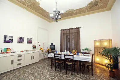 a kitchen and dining room with a table and chairs at Rest and Go in Palermo