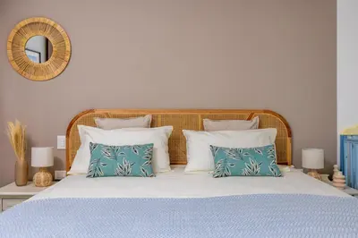 a bedroom with a bed with blue and white pillows at Villa Bonifato vista sulle campagne e sul mare siciliano COZY HOUSE ITALY in Alcamo