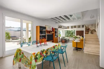a room with a table and chairs and a kitchen at Villa Bonifato vista sulle campagne e sul mare siciliano COZY HOUSE ITALY in Alcamo