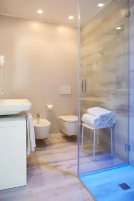 a bathroom with a glass shower and a toilet at Marina di Petrolo Hotel & SPA in Castellammare del Golfo