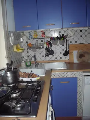 a kitchen with blue cabinets and a sink and a stove at Apartment Ro a Mondello in Mondello
