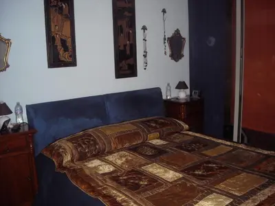 a bedroom with a bed with a blue head board at Apartment Ro a Mondello in Mondello