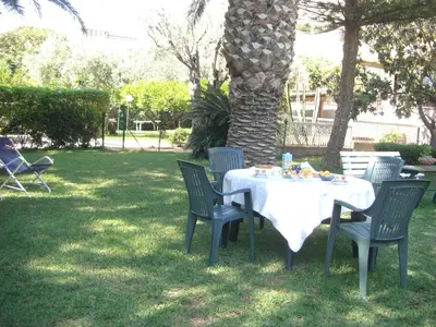 a table and chairs sitting under a tree at Villa Ania in Mondello