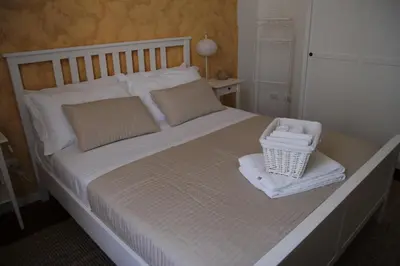 a bedroom with a large bed with a basket on it at B&B Gallidoro in Palermo