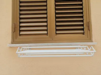 a window with a shutter on a wall at 