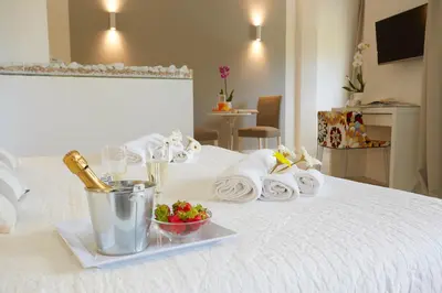 a tray of towels and a bowl of fruit on a bed at B&B Mondello Design in Mondello