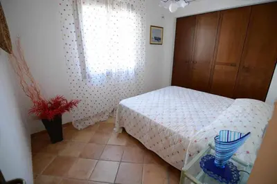 a small bedroom with a bed and a window at Dune Home alloggi sul mare in Alcamo Marina
