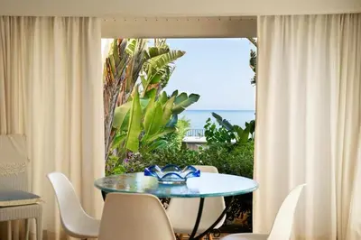 a table in a room with a view of the ocean at Dune Home alloggi sul mare in Alcamo Marina