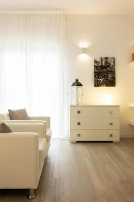 a living room with a white couch and a dresser at Palermo ai Leoni in Palermo