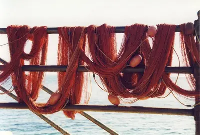 a bunch of red hair hanging from a pole at Seafront House Gabbiano Azzurro in Santa Flavia