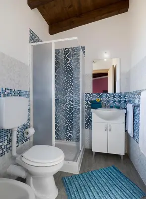 a blue and white bathroom with a toilet and a sink at Arricàmpati Airport Rooms & Bringo Car Rental in Carini