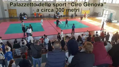 a crowd of people watching a soccer game in a gym at Arricàmpati Airport Rooms & Bringo Car Rental in Carini