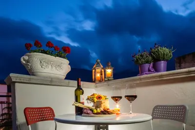 a table with two glasses of wine on a ledge at Arricàmpati Airport Rooms & Bringo Car Rental in Carini