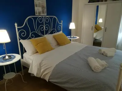 a bedroom with a large bed with two towels on it at La Dimora dei sette Arcangeli in Palermo