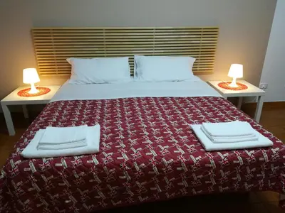 a bedroom with a large bed with two lamps at La Dimora dei sette Arcangeli in Palermo