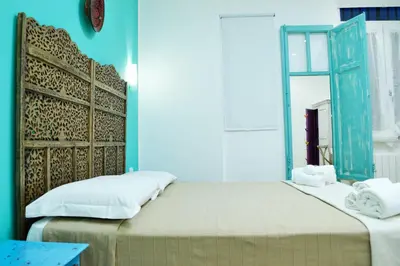 a bedroom with two beds and a mirror at Piazza Marina in Palermo
